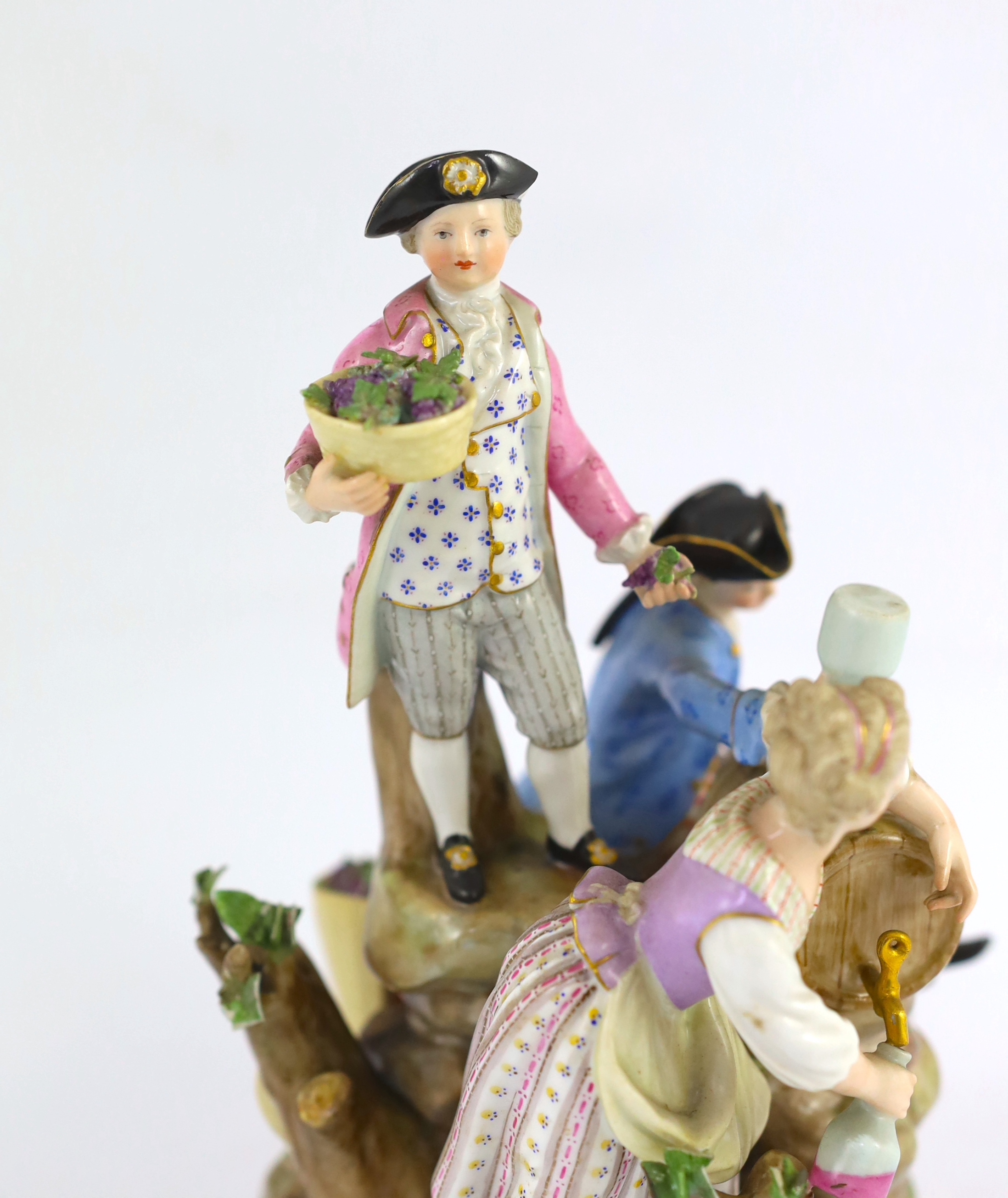 A Meissen group of grape pickers with barrels of wine, 19th century, chips to hats